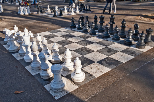Geneva / Switzerland - January 10 2020 : playing traditional oversized street chess in Parc des Bastions