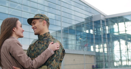 Male soldier smiling and talking with wife.