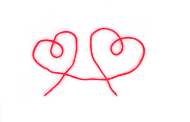 Red thread in shape of heart on white isolated background. Stock photo for Valentine's Day with...