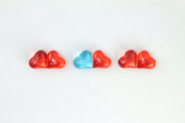 Blue and red glass hearts  on white background. Stock photo for Valentine's Day with empty place...