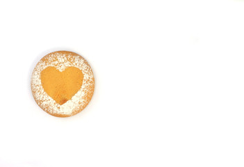 Heart shaped round cookie with icing sugar pattern on white isolated background.  Valentine's day stock photo with place for text. For web, print, holiday cards, invitations, wallpapers.