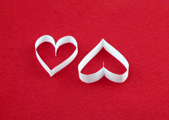 A pair of white hearts on a red felt background with an empty place for your text. Valentine's day stock photo for web, print, postcards, invitations, wallpaper and background.