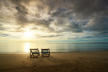 Two Beach Chairs standing in beach with beautiful sea and sunlight in background at island in Phuket, Thailand. Summer, Travel, Vacation and Holiday concept.