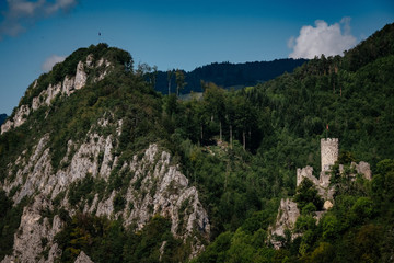 Fototapeta na wymiar romantic castle on top of a hill in a mountainous valley