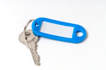 key with a blue tag on a white background, top view
