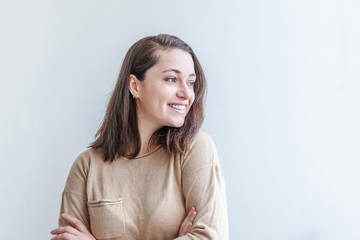 Obraz premium Happy girl smiling. Beauty portrait young happy positive laughing brunette woman on white background isolated. European woman. Positive human emotion facial expression body language