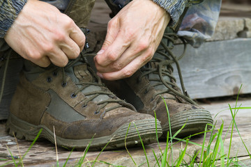 hands tie shoelaces on shoes
