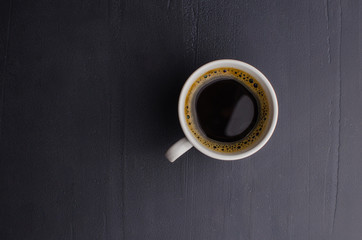 Black closeup on dark backdrop. Coffee espresso on dark background.