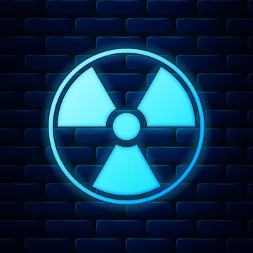 Glowing neon Radioactive icon isolated on brick wall background. Radioactive toxic symbol. Radiation Hazard sign. Vector Illustration