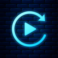 Glowing neon Video play button like simple replay icon isolated on brick wall background. Vector Illustration