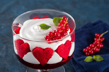 Cake Red Velvet in the shape of a heart with red currants. Valentine's Day.