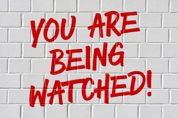 Graffiti on a brick wall - You are being watched