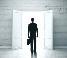 Fototapeta premium Businessman in room with open door to success.