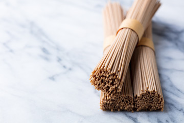 Noodles soba on white marble background. Traditional asian food. Copy space. Top view.