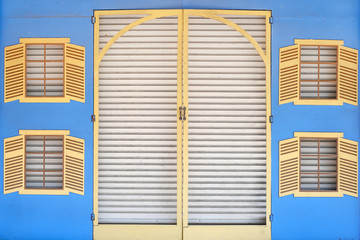 metal door and window on blue wall background
