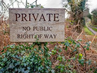 Wooden sign post at the entrance to a private lane preventing hikers and walkers from taking the...