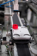 Close up of an automated car which is loaded at distribution station of smart factory prototype. Industry 4.0 smart factory concept; using artificial intelligence and Internet of Things in production.