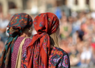 Fototapeta premium woman in traditional costume, two Gypsies girls on their back, with headkerchiefs