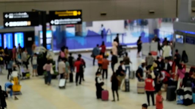 Blurred and unrecognizable people waiting to check in at the airport