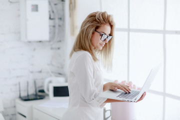 Woman businesswoman in glasses works in the office.