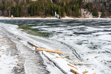 Predil lake in winter dress. Ice and reflections on the water. Tarvisio, Italy