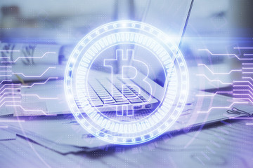 Double exposure of blockchain theme hologram and table with computer background. Concept of bitcoin crypto currency.