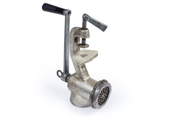 Inverted old hand meat grinder on a white background