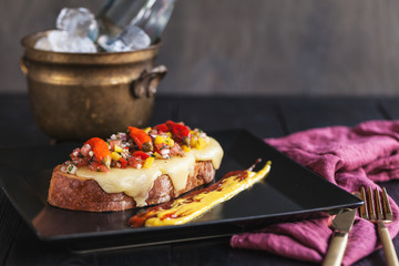 bruschetta with cheese, vegetable salsa and pickled hot peppers