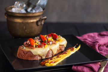 bruschetta with cheese, vegetable salsa and pickled hot peppers