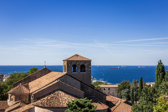 Trieste, Italy - September 2019: Roman catholic cathedral 'Basilica cattedrale di san giusto martire' with view to the mediterranean sea. It's dedicated to saint justus and the church of the bishop.