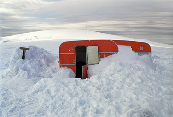 Trailer partly buried in snow