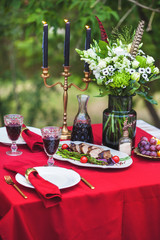 duck breast with grilled asparagus and cherry tomatoes on a table with candles, outdoor summer
