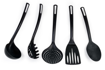 Different plastic cooking utensils on a white background