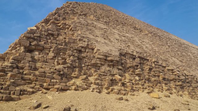 The Bent Pyramid is an ancient Egyptian pyramid located at the royal necropolis of Dahshur, approximately 40 kilometres south of Cairo, built under the Old Kingdom Pharaoh Sneferu. Egypt