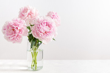 Lovely flowers in glass vase. Beautiful bouquet of pink peonies. Floral composition, copy space....