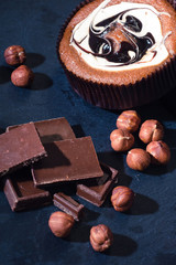 Muffins with chocolate and nuts in white glaze