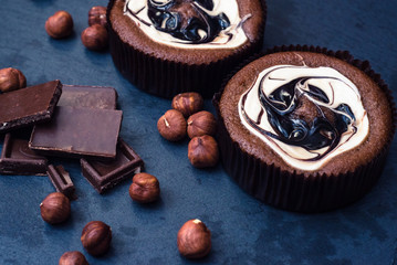 Muffins with chocolate and nuts in white glaze