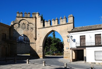 Fototapeta na wymiar View of the Arco de Villalar with the Puerta de Jaen to the right in the Plaza de Populo, Baeza, Spain.