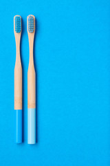 Toothbrushes on blue background top view