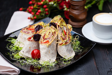 doner kebab with ham and cheese in a plate with microgreen