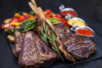 grilled set of steaks, t-bone and vegetables