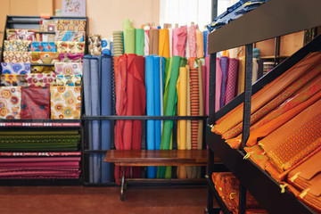 Obraz na płótnie Canvas Colorful textiles on racks and shelves in a fabric shop