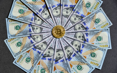 Golden bitcoin on USD 100 billnotes