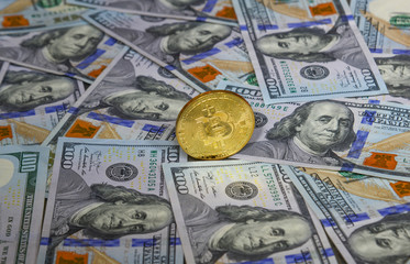 Golden bitcoin on USD 100 billnotes
