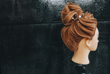 Training hair styling on a mannequin