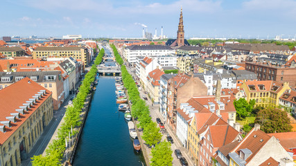 Obraz premium Beautiful aerial view of Copenhagen skyline from above, Nyhavn historical pier port and canal with color buildings and boats in the old town of Copenhagen, Denmark