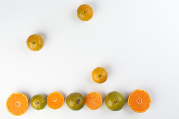 small yellow green mandarin orange whole slice on white background copy space for text frame border