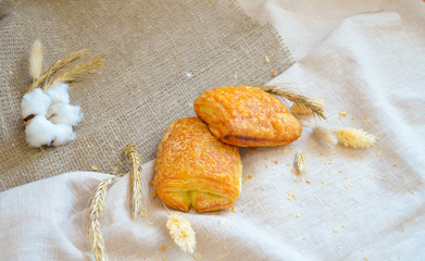 Flaky buns lying on a tablecloth