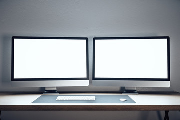 Designer desktop with two empty computer monitor