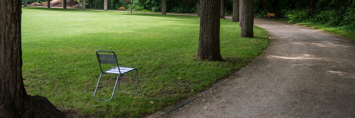 Walkway in a city park in the morning.  Web banner.